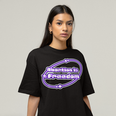 Celebrate choice and freedom with our Pro Choice feminist tshirt featuring a vibrant Y2K-style graphic that boldly declares "Abortion is Freedom." Embrace your activism and stand for reproductive rights with this stylish statement piece. Shop social justice feminist apparel