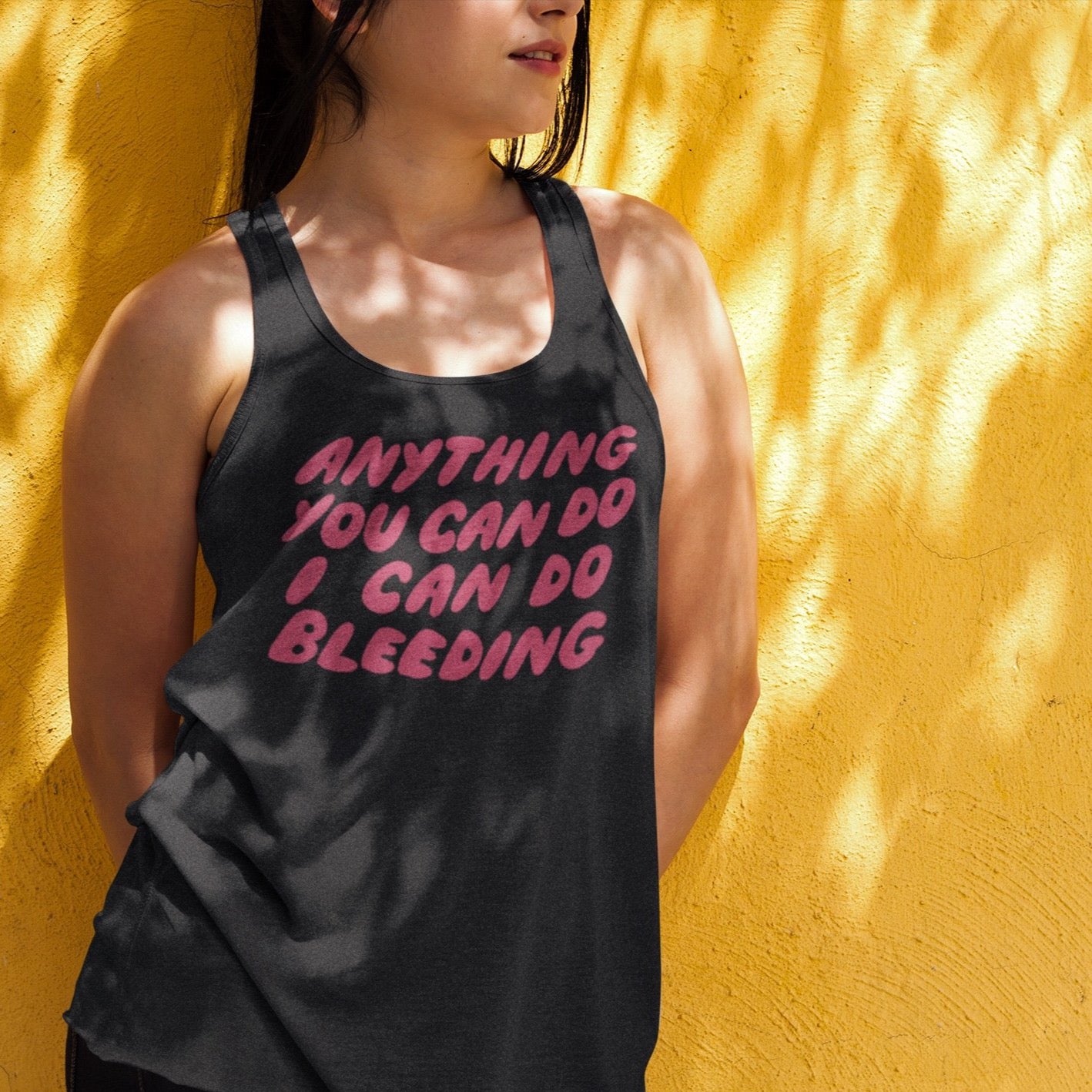 Black Feminist Tank Top that says anything you can do i can do bleeding in red hand-lettered writing- Shop Feminist Apparel