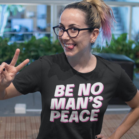 Black feminist tee that says be no man's peace in bold white writing with pink accents- Shop feminist apparel