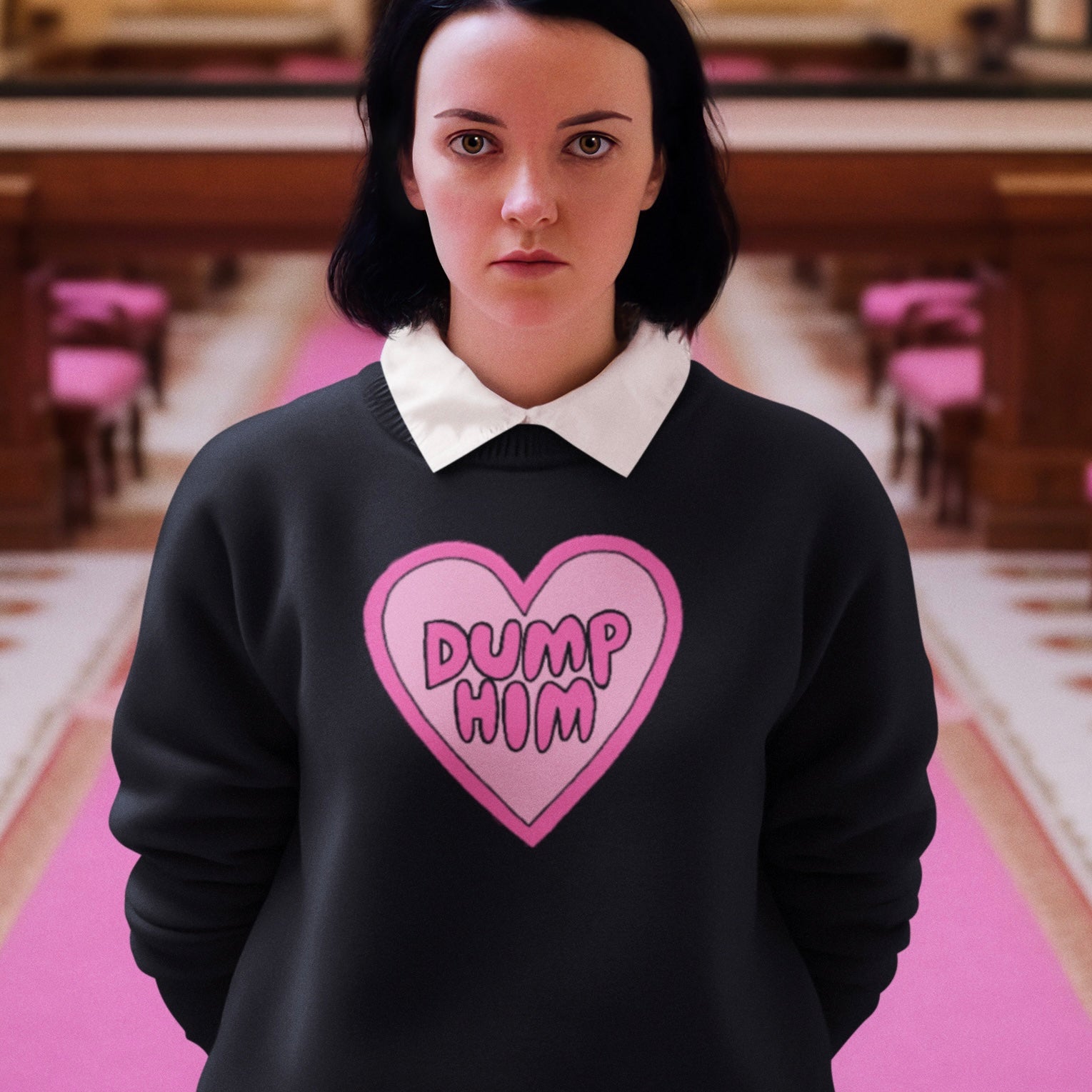 Image of a black dump him sweatshirt with a hand-illustrated heart and 'Dump Him' hand-lettered in bubble writing. This bold feminist sweatshirt is a statement of independence and empowerment. Shop our feminist apparel today!