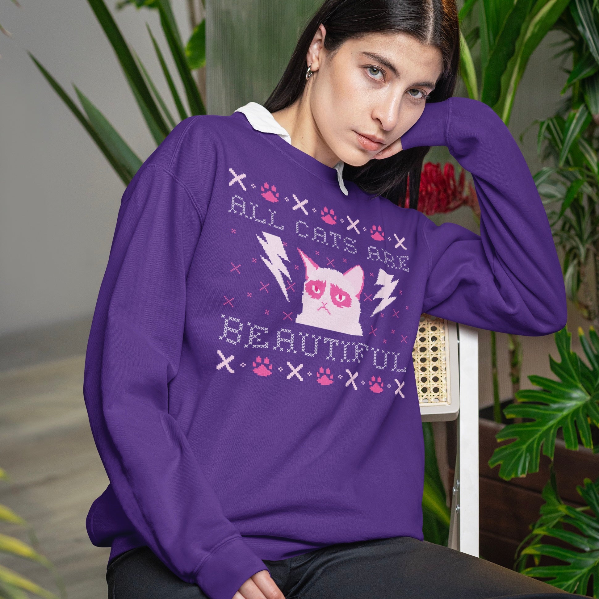 Christmas themed ACAB sweatshirt Featuring a cross stitch styled design of an angry cat with the words all cats are beautiful. Shop feminist trash for ugly Christmas sweatshirts and political clothing