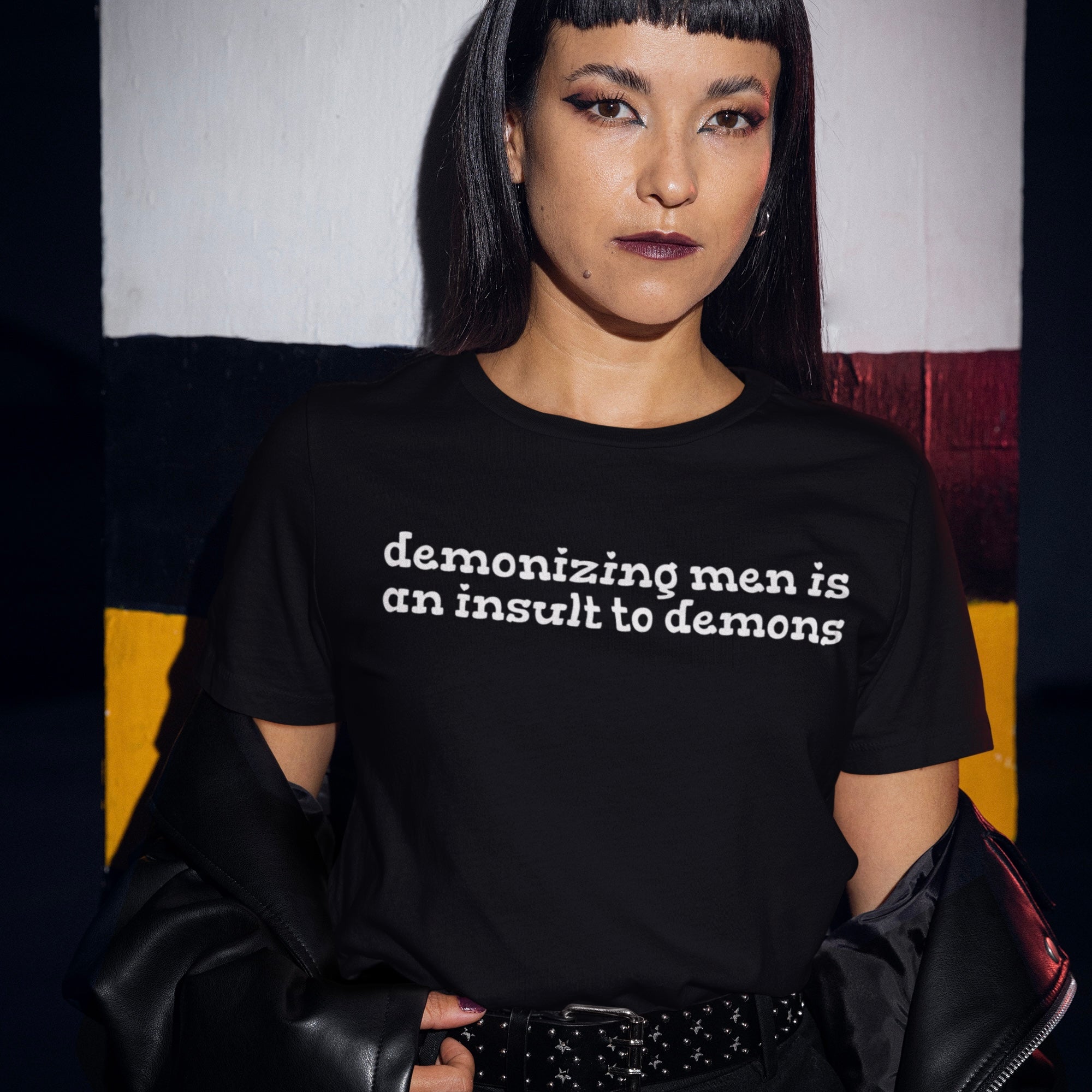 Black feminist tee that says Demonizing men is an insult to demons in white writing- shop feminist trash for feminist clothing and dump him shirts.