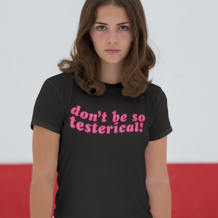 Black feminist tee that says Don’t Be So Testerical! In pink wavy writing. Shop Women’s Rights T-shirts and feminist clothing.