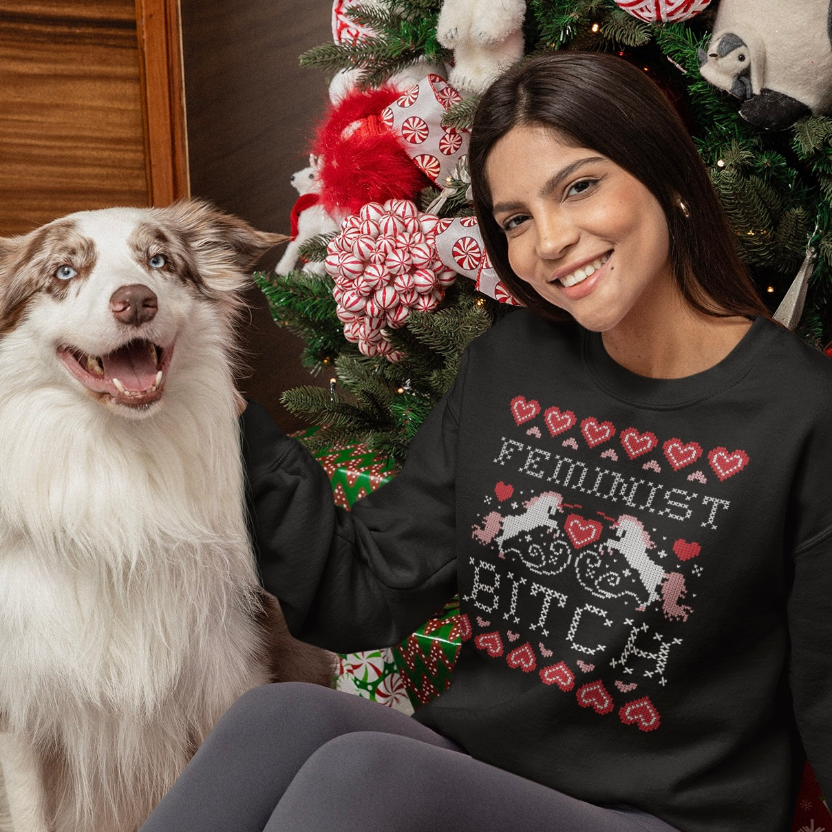 Feminist themed Ugly Christmas sweatshirt that says feminist bitch in cross stitch font featuring cross stitch unicorns and hearts. Shop feminist trash for feminist clothing and gifts for feminists.