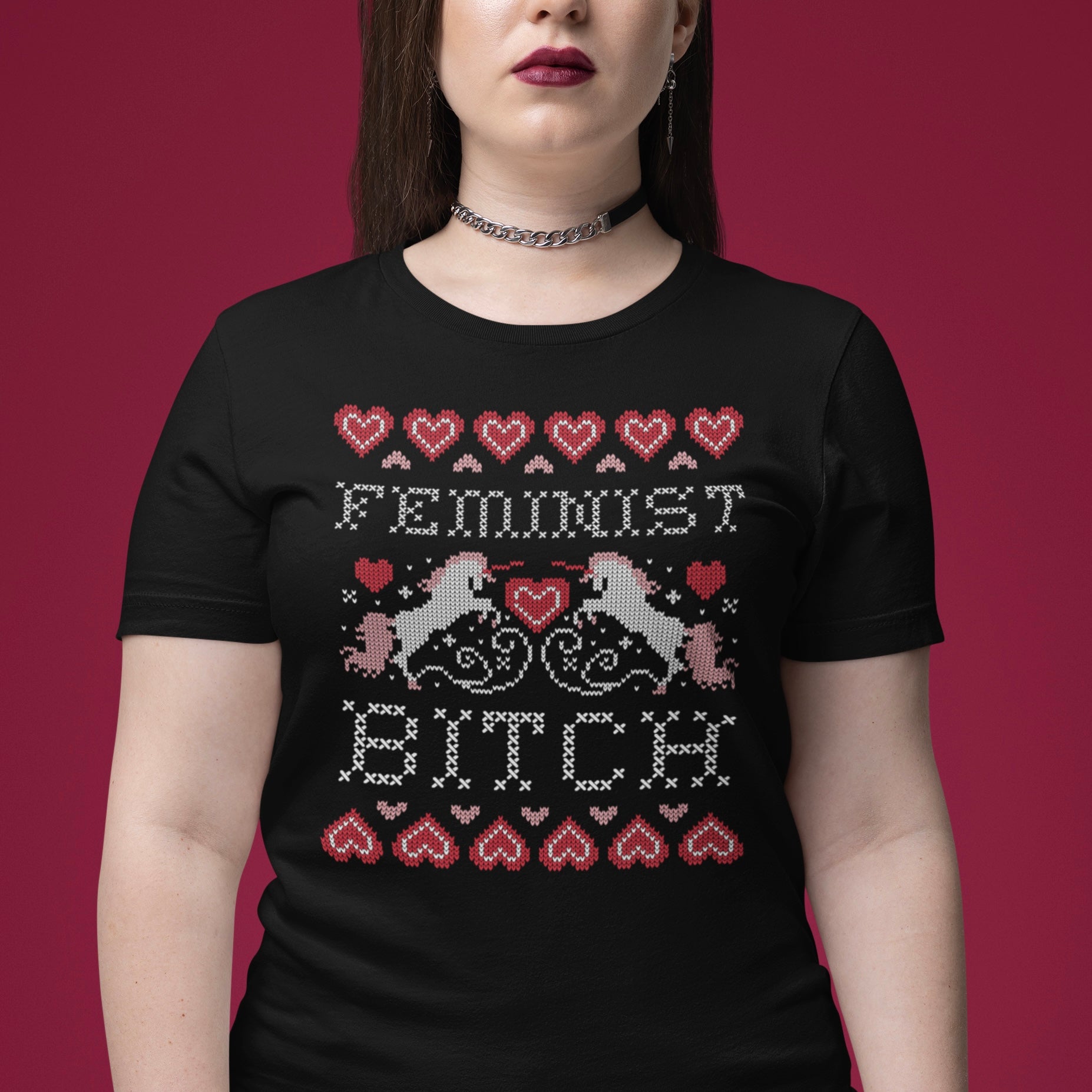 Black Christmas themed feminist tee that says feminist bitch in a cross stitch unicorn pattern- shop feminist trash for feminist clothing