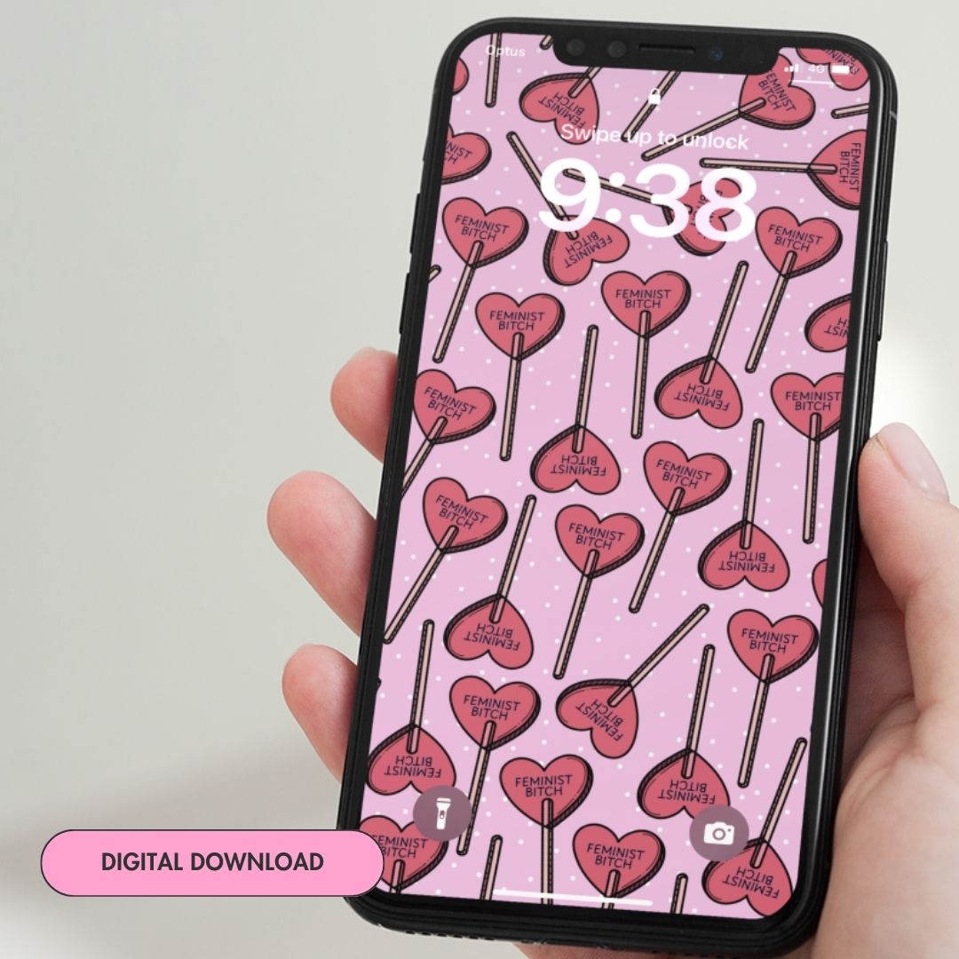 digital download of feminist phone wallpaper featuring a red heart lollipop pattern that says feminist bitch on a pink background. Shop feminist trash for phone backgrounds and feminist t-shirts