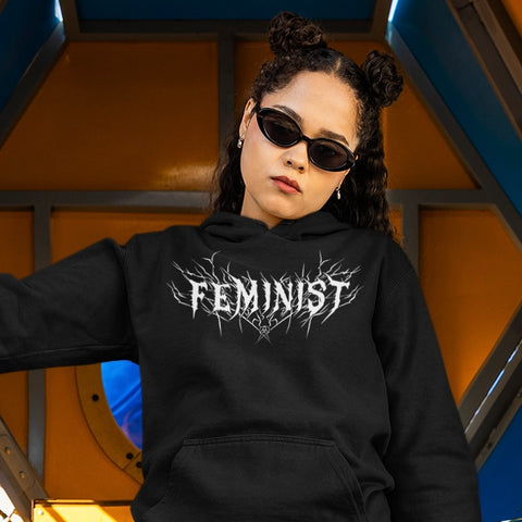 black feminist hoodie that says feminist in white heavy metal writing- shop feminist trash for feminist apparel, dump him shirts, political clothes and pride merch