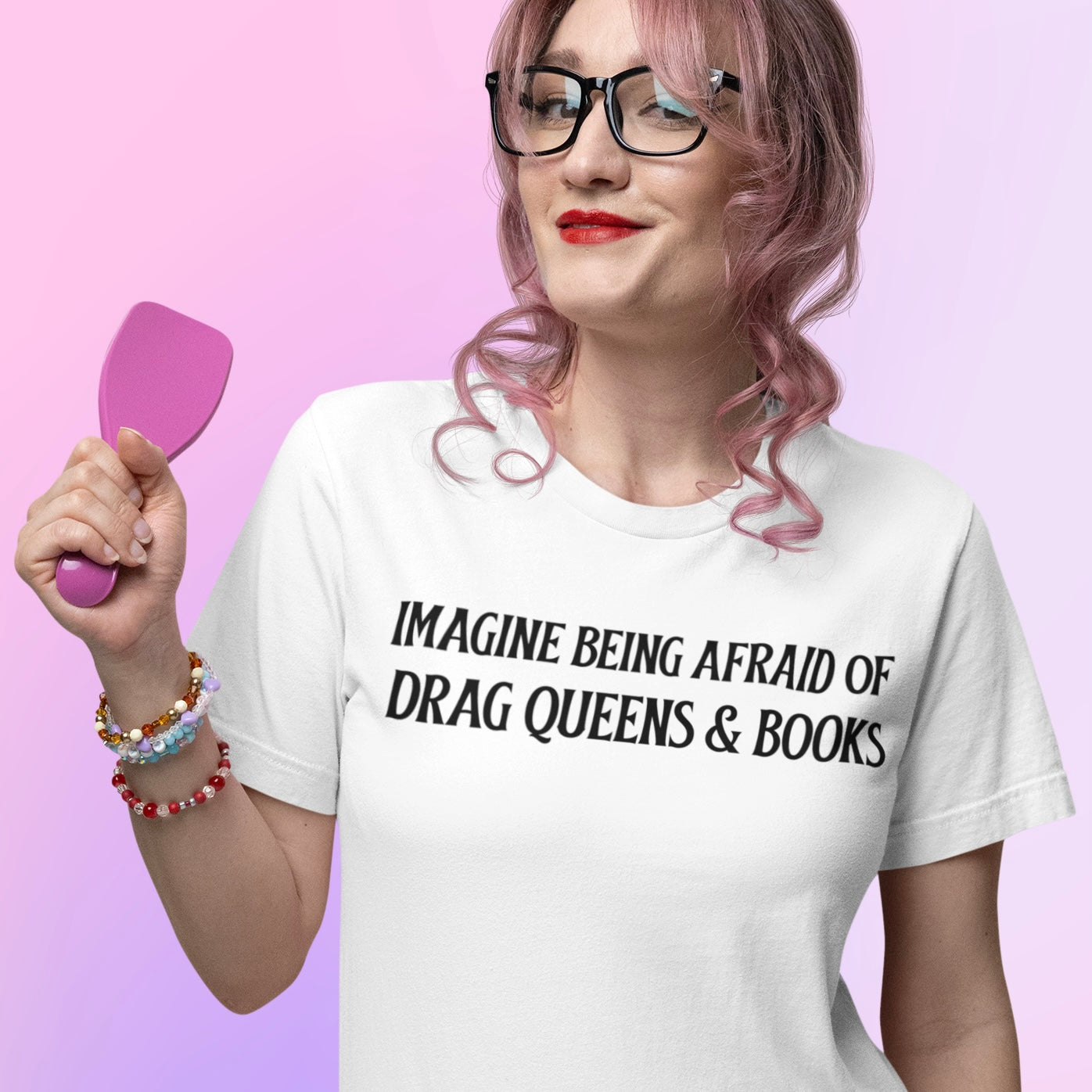 white pride t-shirt that says imagine being afraid of drag queens and books in black writing. Shop Feminist Trash for pride merch, political clothing and feminist shirts