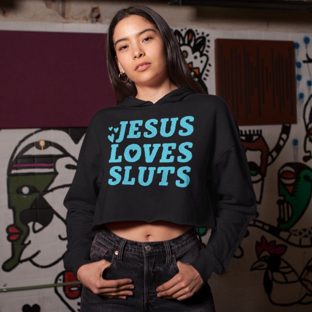 Cropped black feminist hoodie that says jesus loves sluts in bold blue writing- shop feminist tees and social justice apparel