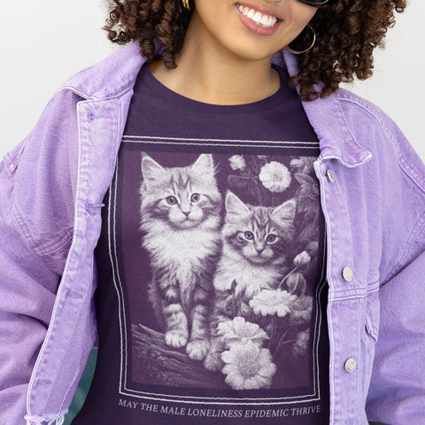 purple feminist t-shirt that says may the male loneliness epidemic thrive in light purple writing featuring a mono gram photograph of two kitten. Shop Feminist Trash Store for feminist tees, political clothing and cat lady tshirts.