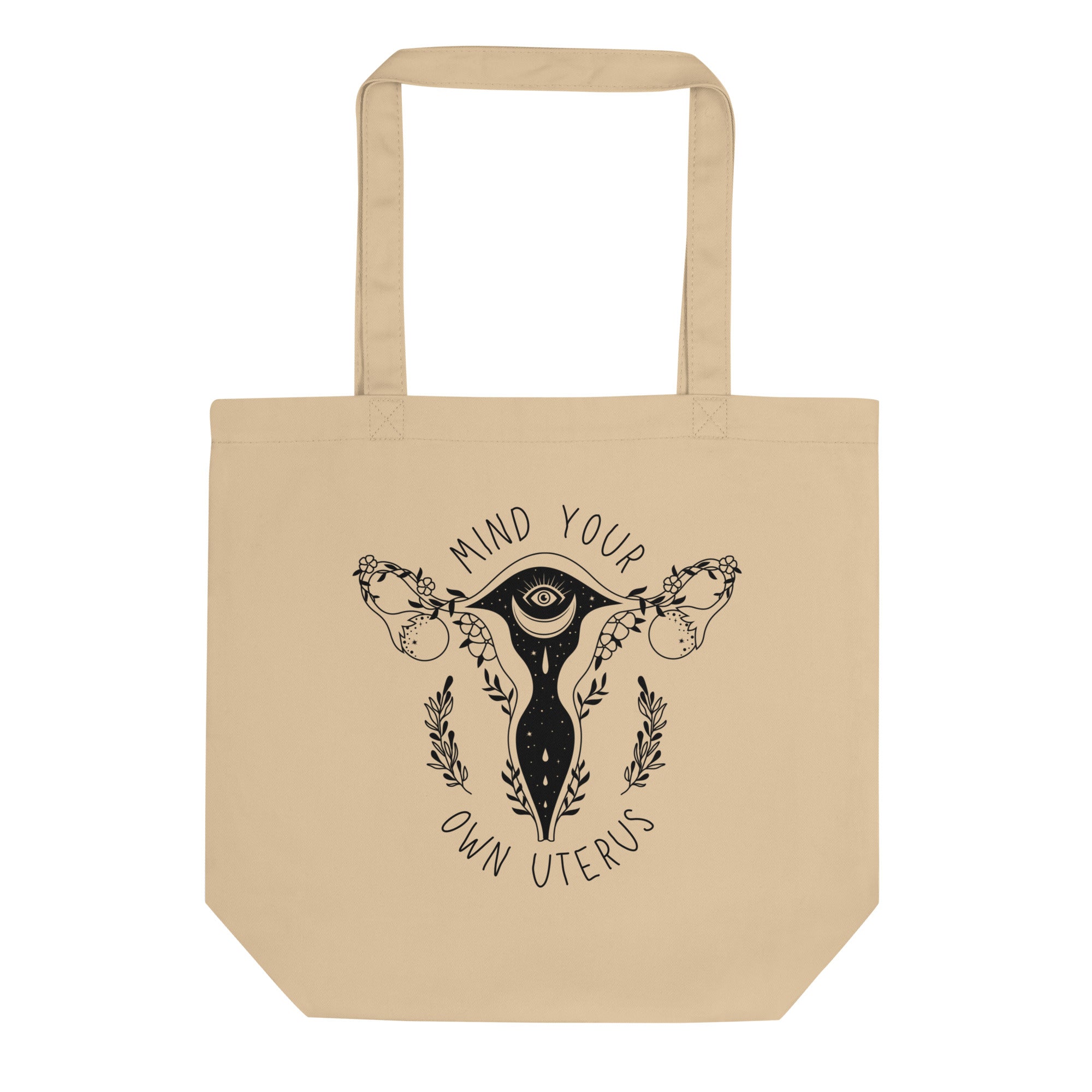 Beige/oyster coloured tote bag featuring a witchy uterus design with the pro choice phrase Mind your own uterus in black writing- shop feminist trash for feminist apparel and political t-shirts