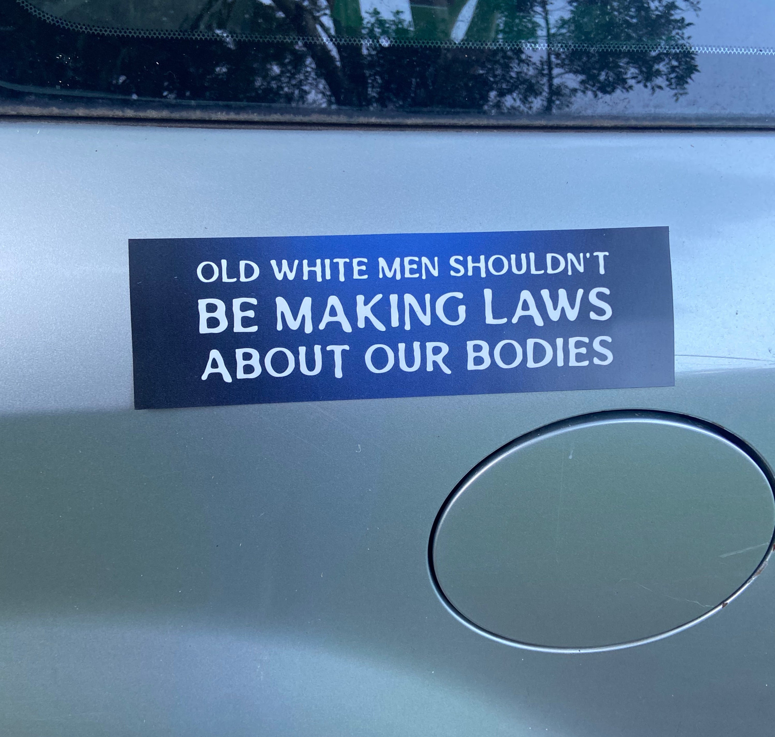 Car magnet that says 'Old white men shouldn't be making laws about our bodies'. In white writing- shop feminist trash for political bumper stickers and women’s march merchandise