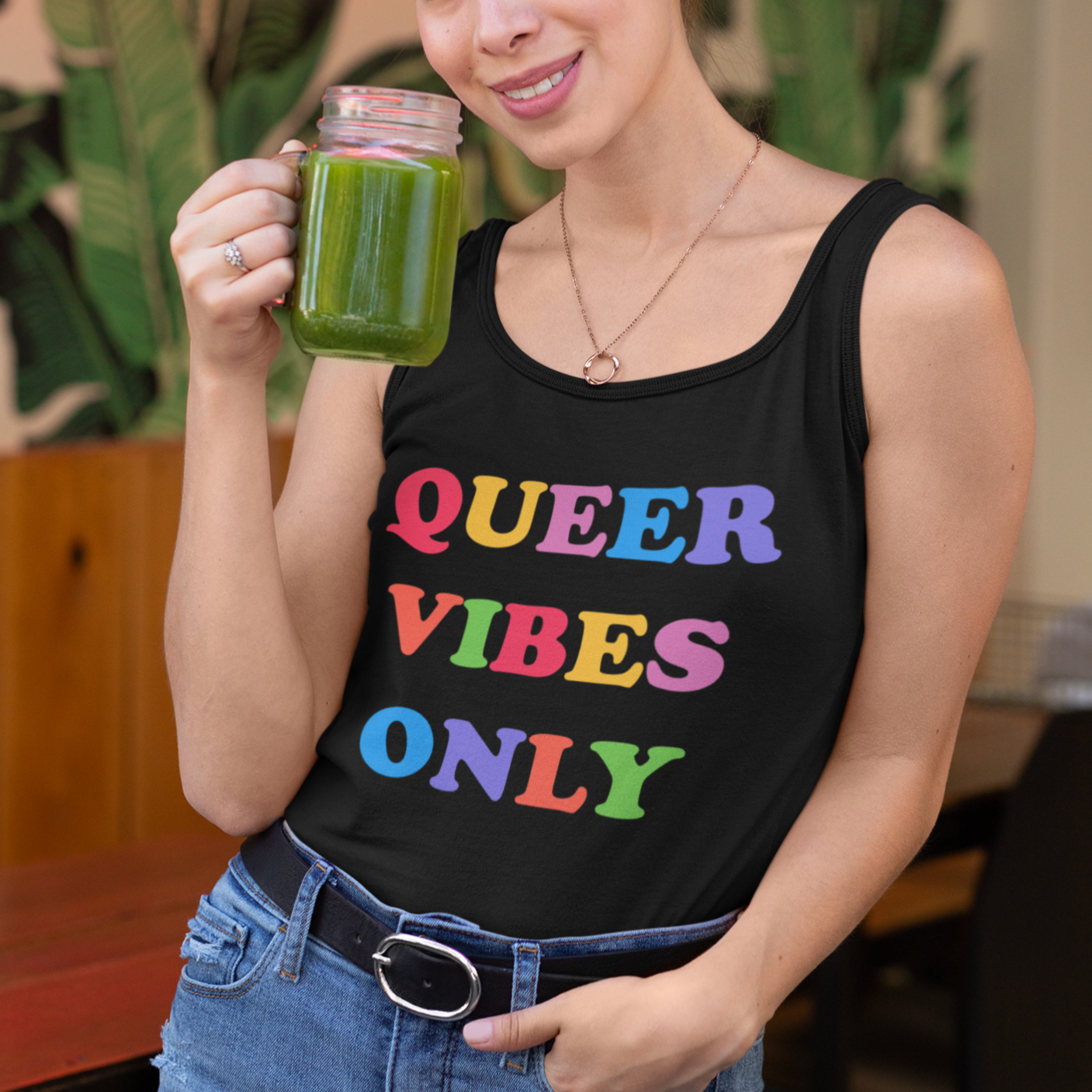 black pride tank top that says queer vibes only in rainbow retro writing- define pride with our pride clothing and dump him shirts