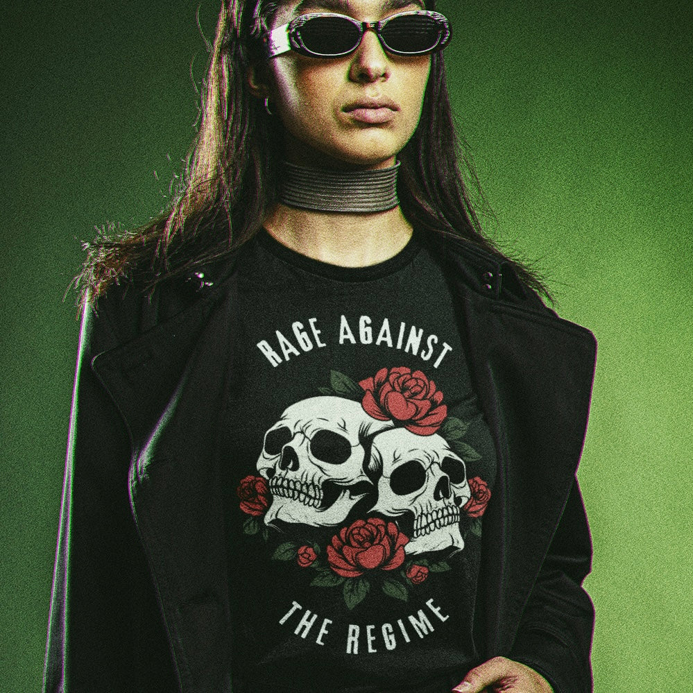 black political shirt that says rage against the regime in white writing- featuring two skulls surrounded by roses. Shop feminist trash for political shirts and anti fascist clothing.
