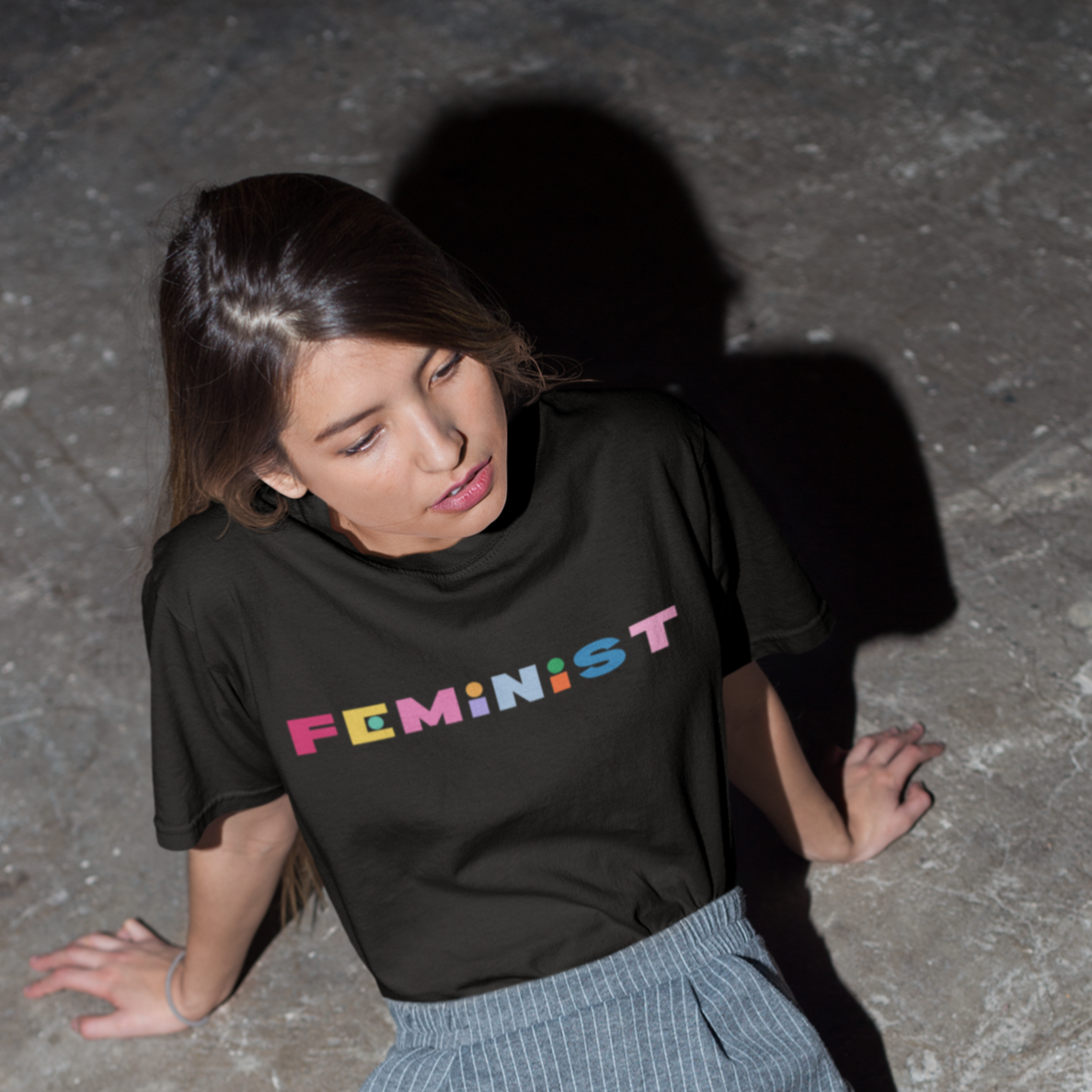 Black feminist tshirt that says feminist in rainbow bold writing- Shop social justice tees