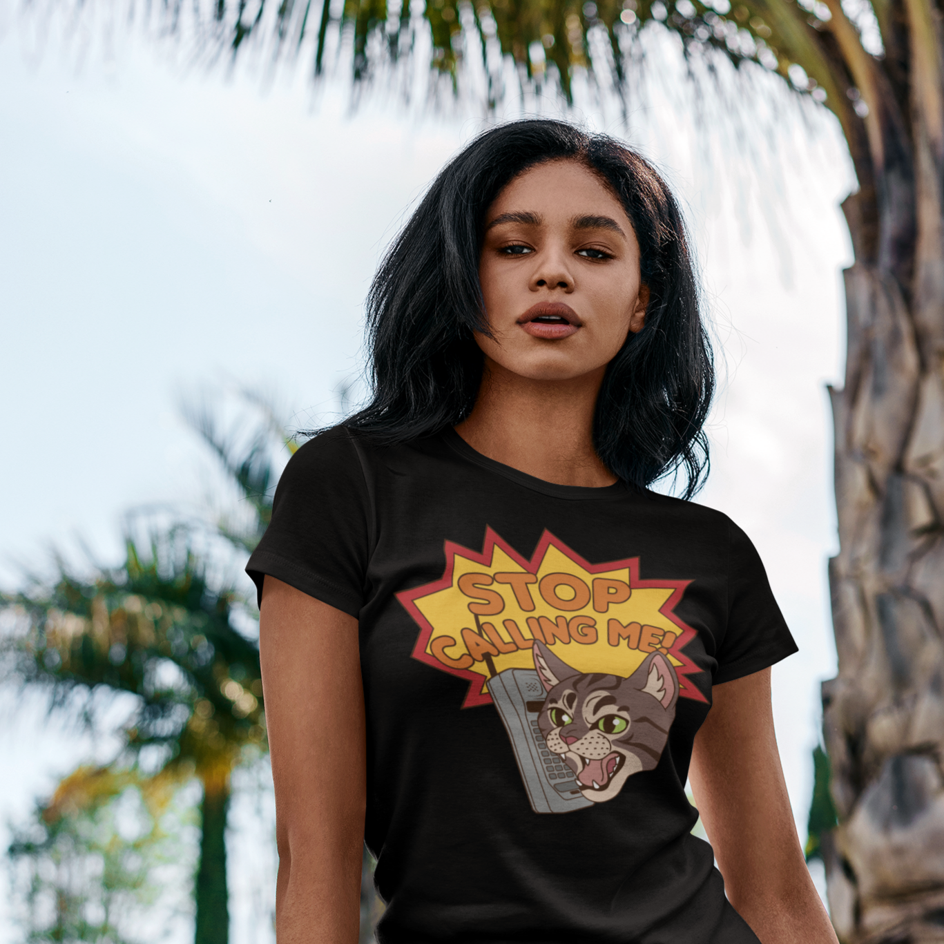 Image of a black feminist t-shirt with 'Stop Catcalling Me' in bold white text. This shirt is a statement against street harassment and promotes respect for women's boundaries. Say no to catcalls today!