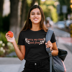 Black feminist tshirt that says sorry my time isn't free in orange writing surrounded by white flowers- shop feminist tees, dump him shirts and political clothing