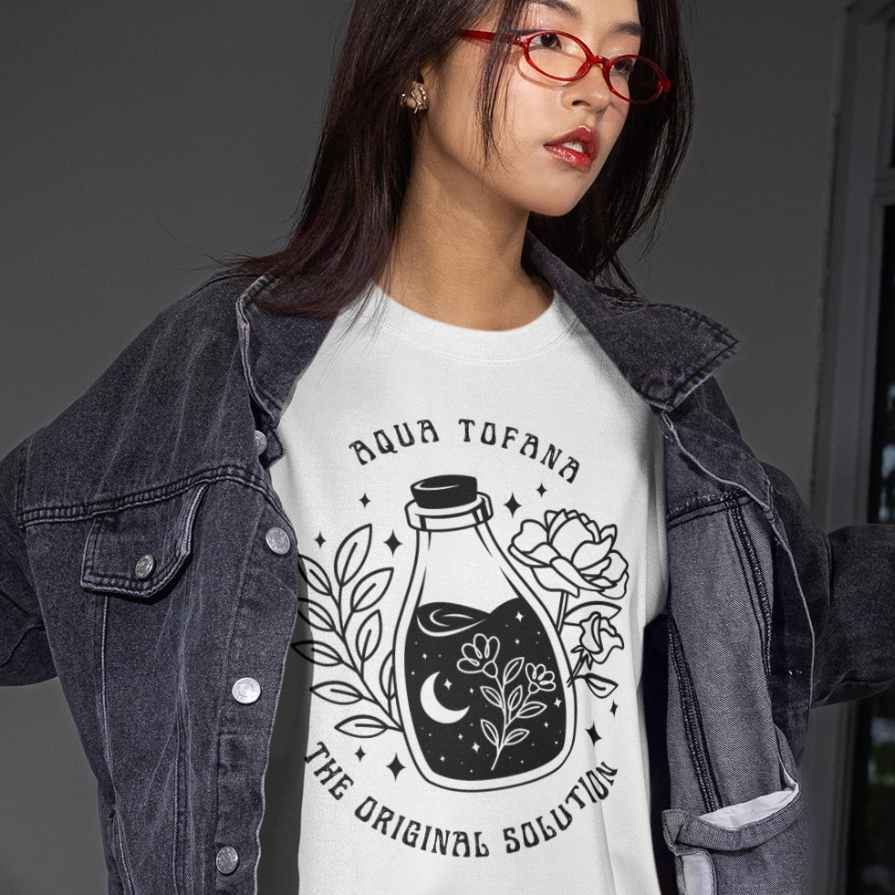 white feminist shirt that says aqua tofana the original solution in black art nouveau sstyle writing. Featuring a black tattoo style illustration of a poison bottle- Shop feminist trash for feminist tees and dump im shirts.