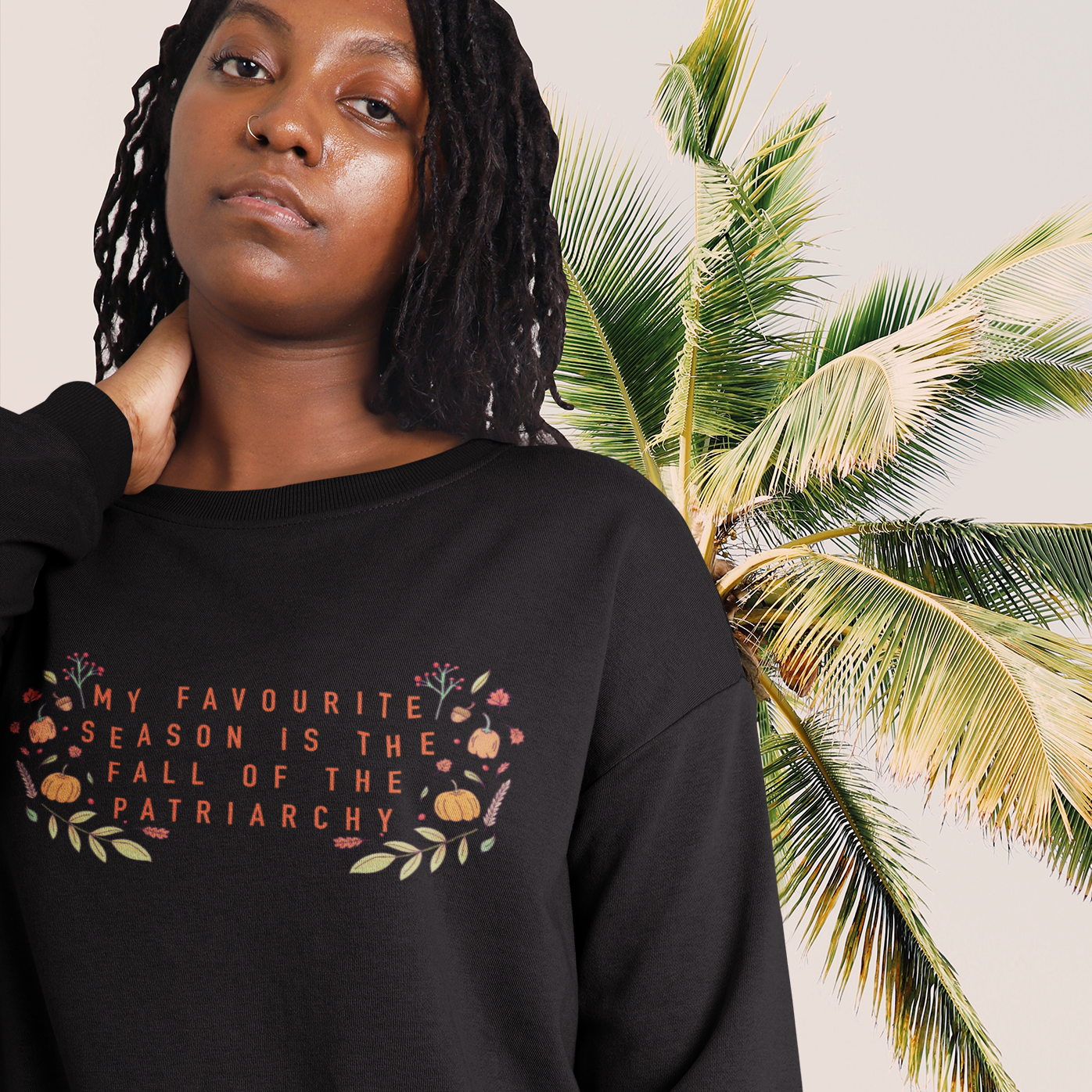 Black feminist sweatshirt with the empowering message 'My Favorite Season is the Fall of the Patriarchy,' advocating for empowerment and gender equality- shop Feminist Trash for feminist sweatshirts and political clothing