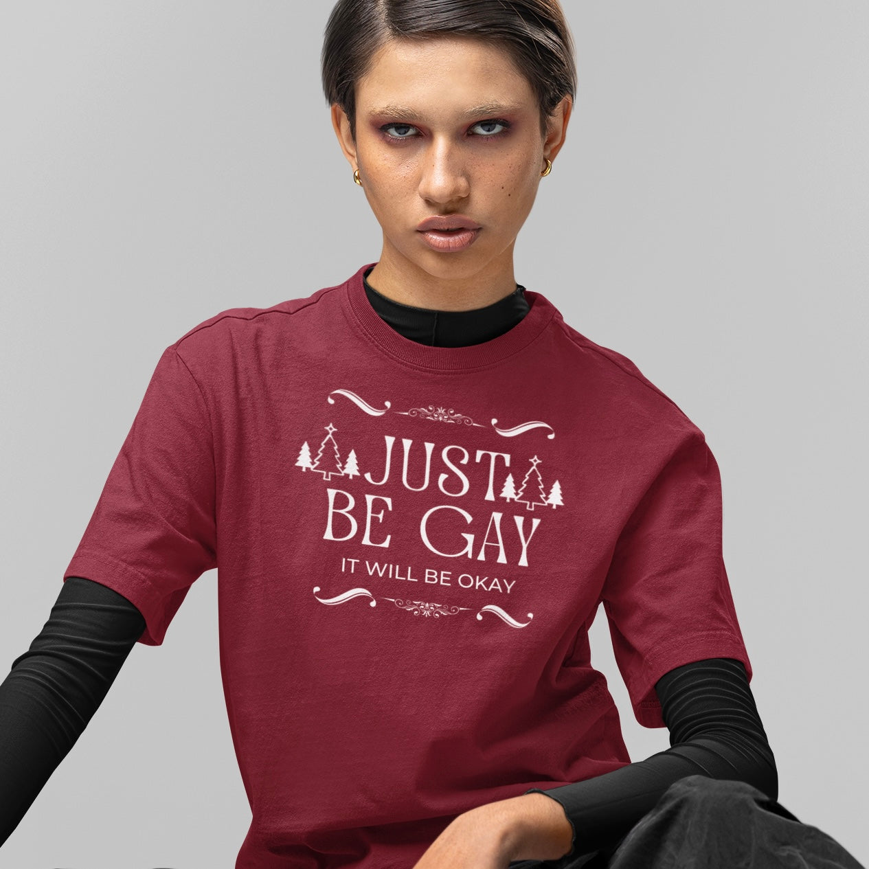 Pride themed Christmas t-shirt that says just be gay, it will be okay! In white writing. Shop feminist trash for pride merch