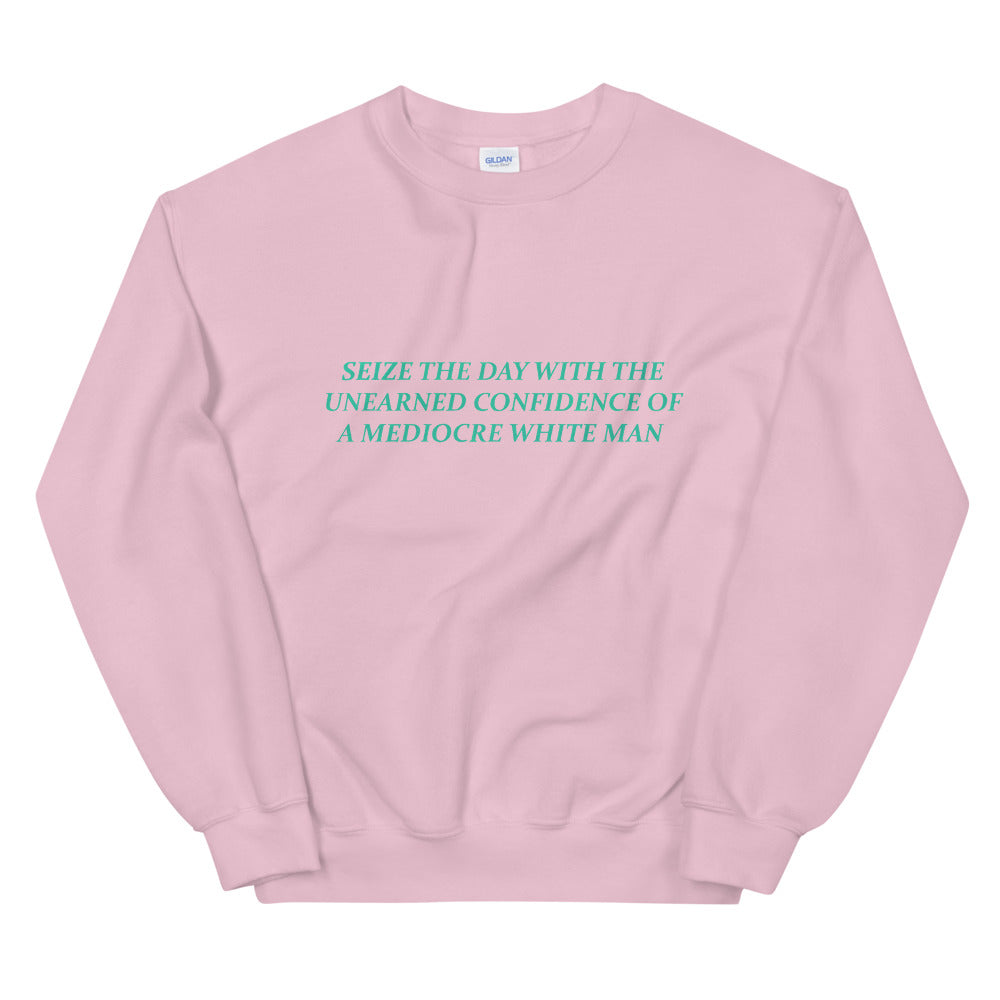 Empowering light pink feminist sweatshirt featuring 'Seize the Day with the Unearned Confidence of a Mediocre White Man,' advocating for empowerment and equality