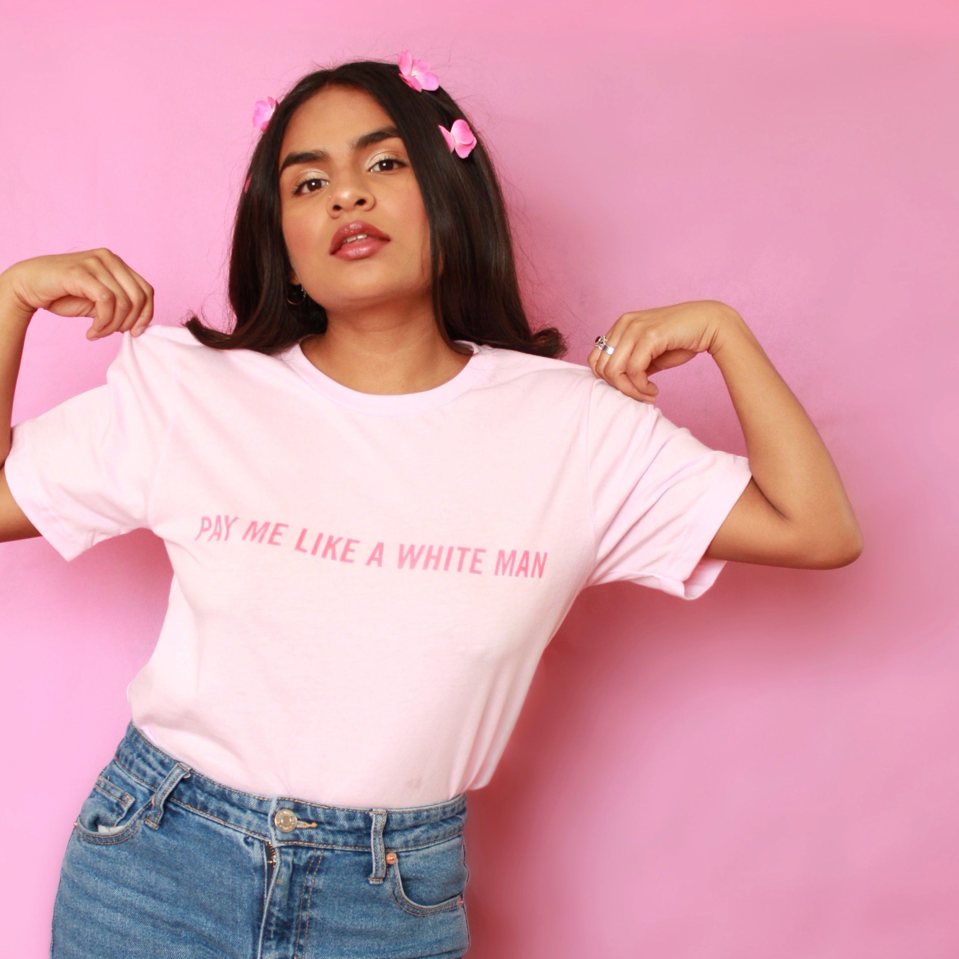 Pink Feminist shirt advocating pay equality, featuring 'Pay Me Like a White Man' slogan in red uppercase hand lettered writing. Shop Feminist Trash for feminist tshirts, dump him shirts, political clothing, pride outfits, presents for book lovers, funny t shirts for women, acab t-shirts and shirts with cats.