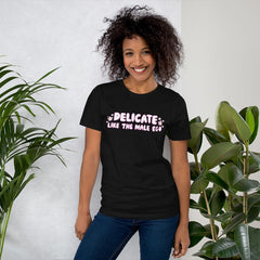 black feminist shirt that says 'Delicate Like the Male Ego in white bubble writing with pink accents and small daisy illustrations- shop feminist tees, dump him shirts and political clothes.