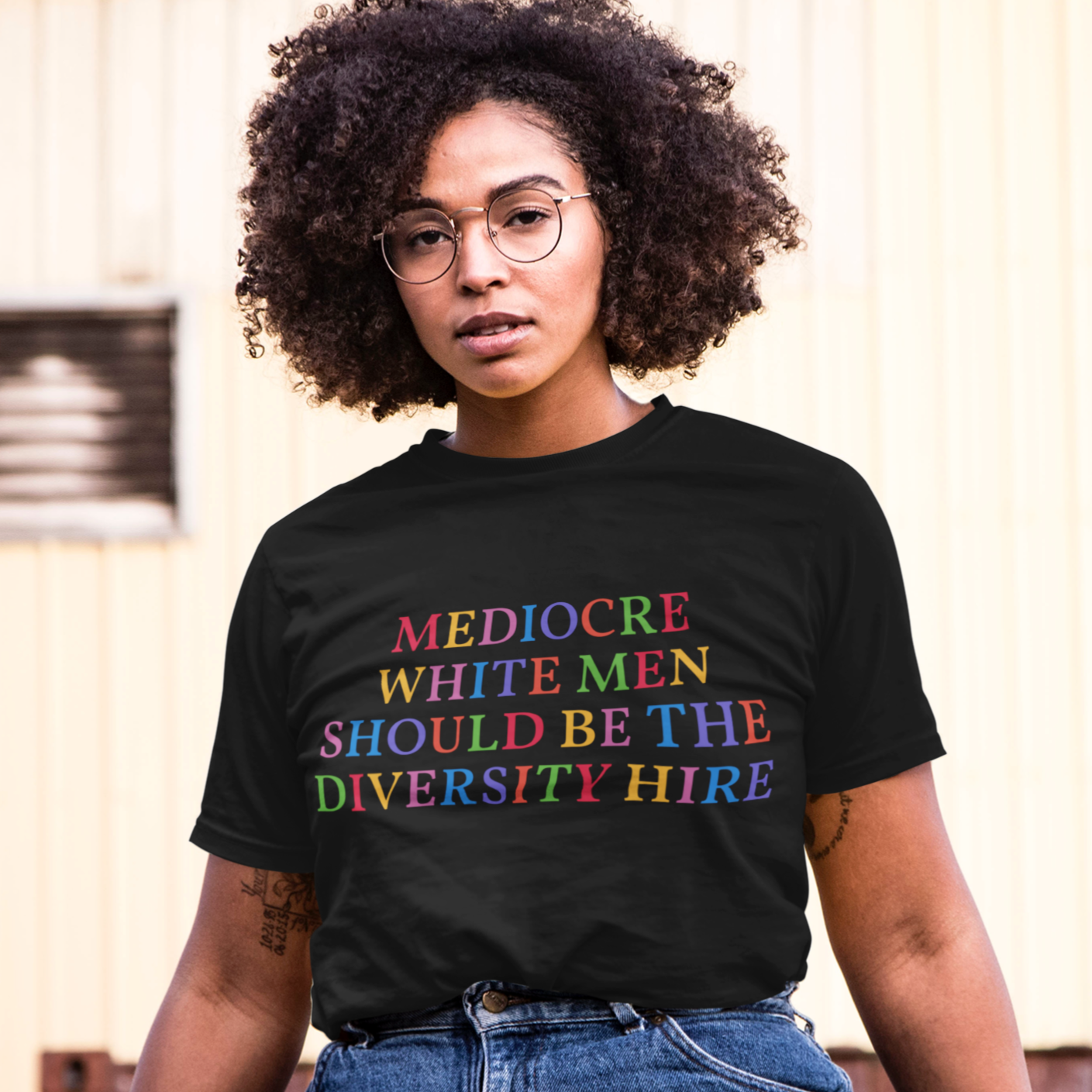 black feminist t-shirt that says Mediocre White Men Should Be The Diversity Hire' in rainbow writing- define feminism with our political clothes, feminist tees and dump him shirts