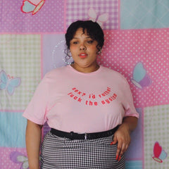 Empowering pink feminist shirt with the message "Sex? I'd Rather Fuck The System" in red writing