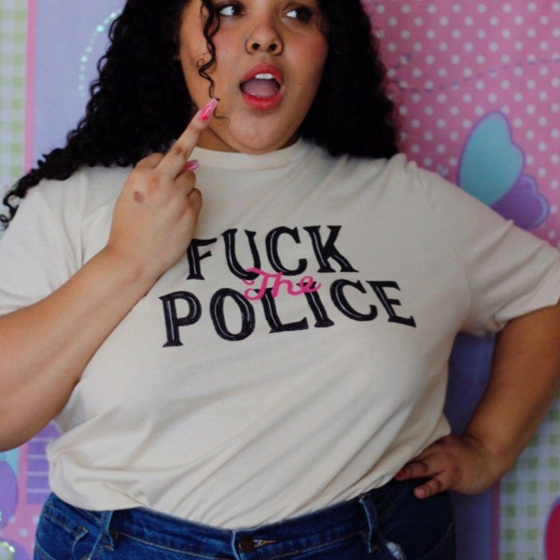 Empowering white feminist t shirt with the message "Fuck the Police" in black and pink writing- Shop Feminist Trash for dump him shirts, political clothing, pride outfits, dump him shirts and witchy outfits