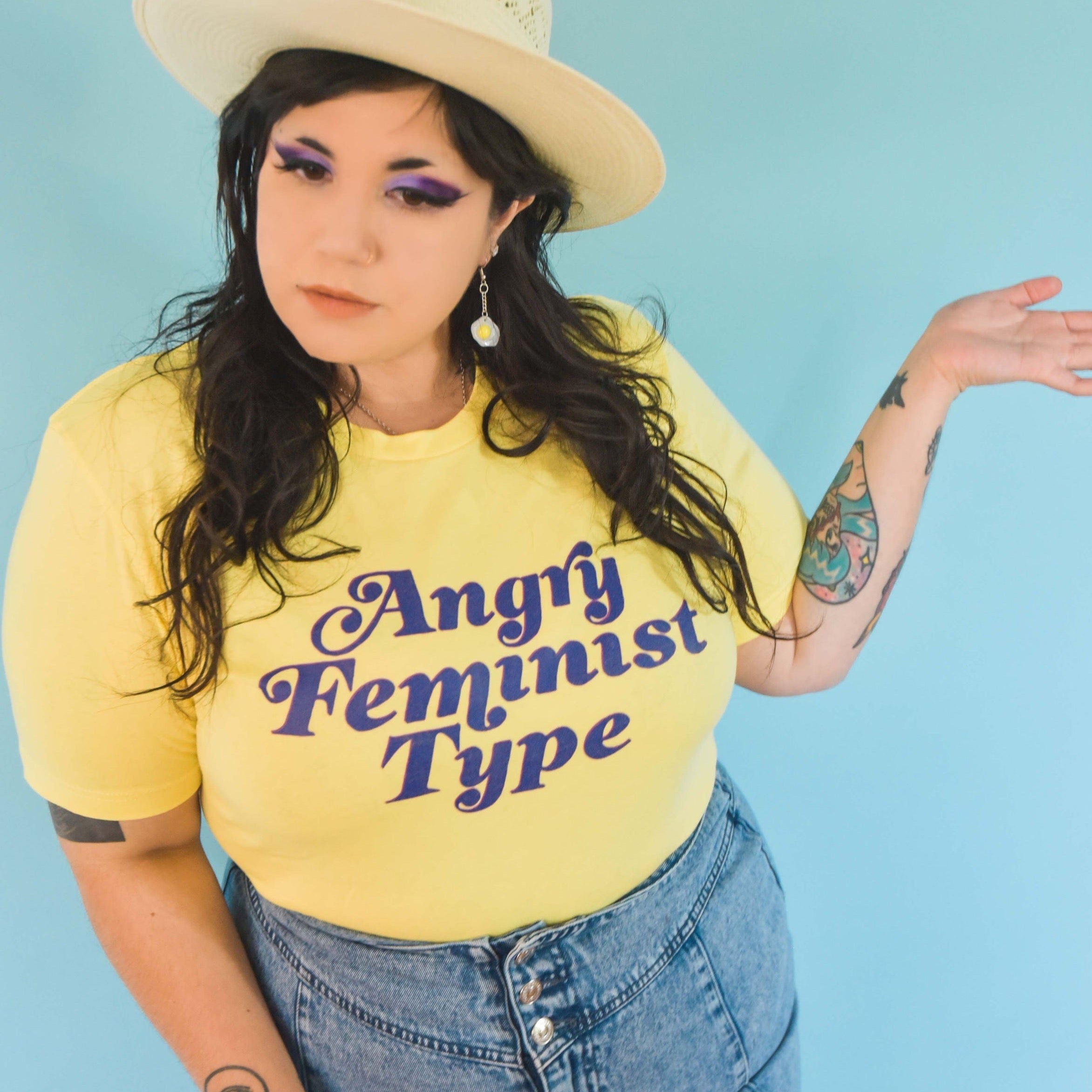 Empowering yellow feminist shirt featuring the strong message "Angry Feminist Type."- Define feminism with our feminist t-shirts, political clothing, dump him shirts, pride clothing and witchy outfits