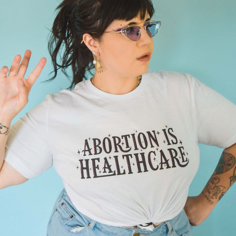 White feminist t shirt with 'Abortion is Healthcare' slogan- Shop feminist tshirts