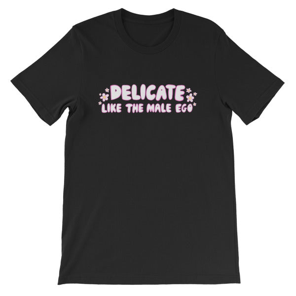 black feminist t-shirt that says 'Delicate Like the Male Ego in white bubble writing with pink accents and small daisy illustrations- shop feminist shirts, dump him shirts and political clothes.