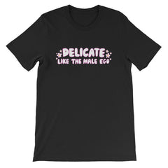 black feminist t-shirt that says 'Delicate Like the Male Ego in white bubble writing with pink accents and small daisy illustrations- shop feminist shirts, dump him shirts and political clothes.