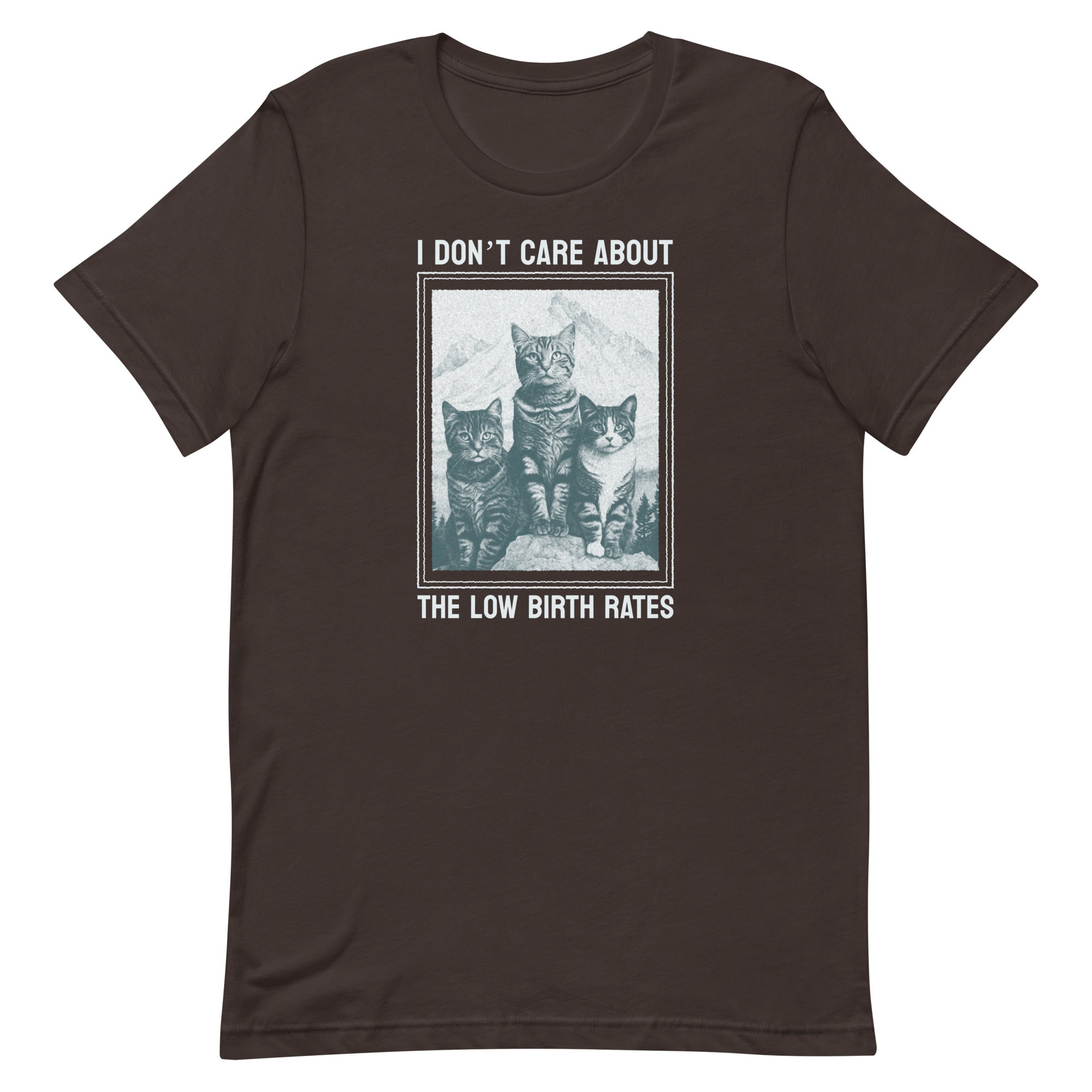 Flat lay of a chocolate brown t-shirt from Feminist Trash featuring three cats and the text "I DON'T CARE ABOUT THE LOW BIRTH RATES." A satirical feminist graphic tee.