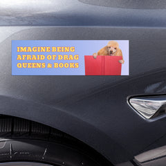 blue gradient political bumper sticker that says imagine being afraid of drag queens & books in yellow bold writing featuring a picture of a golden poodle reading a red book- shop feminist trash store for magnetic bumper stickers, feminist t-shirts and pride shirts