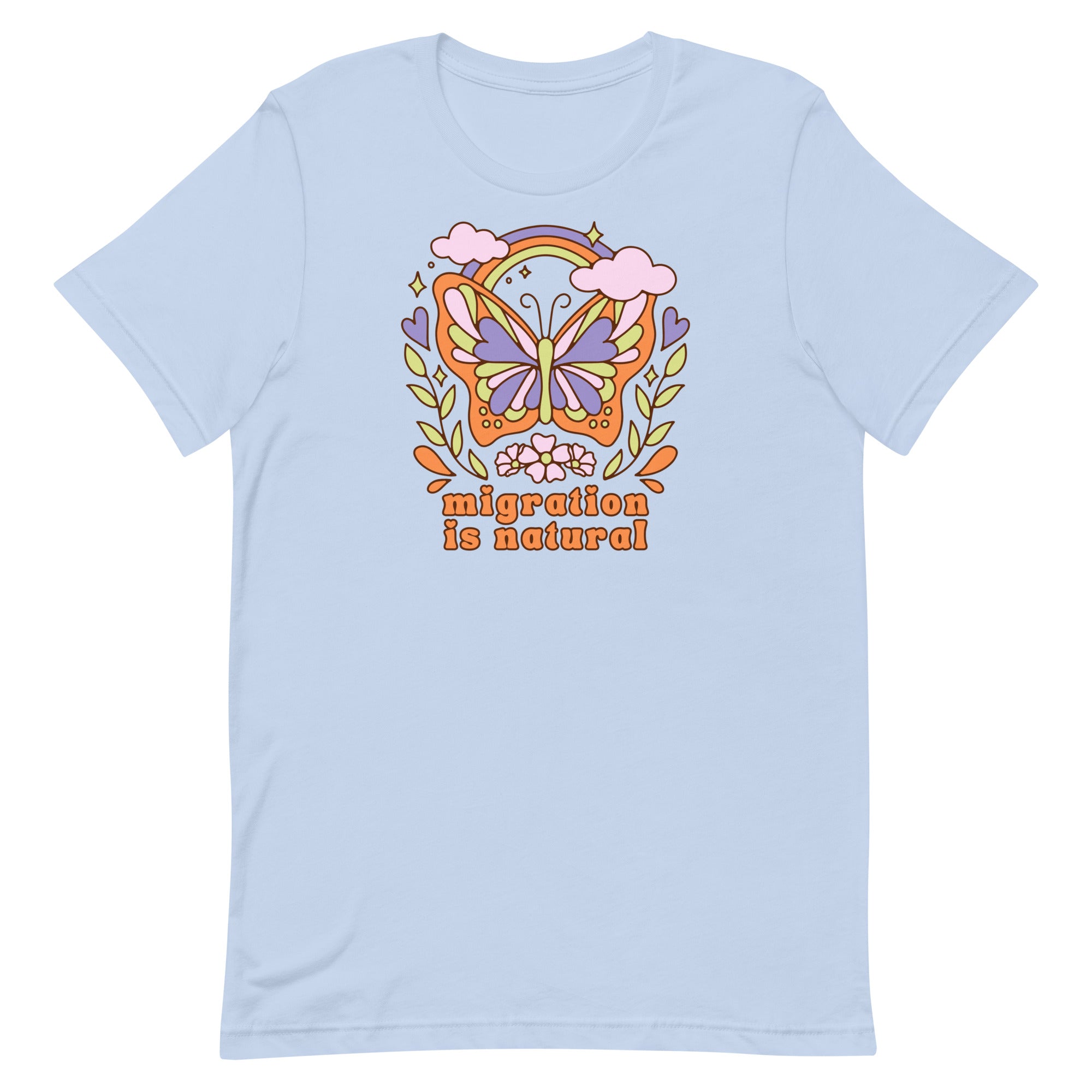 Flat lay of a baby blue t-shirt featuring a colorful retro butterfly illustration with a rainbow and clouds above the text migration is natural in orange groovy typography