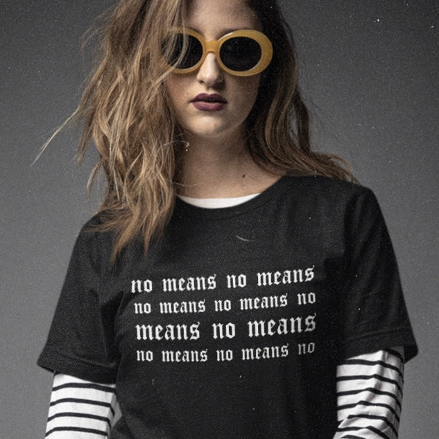 black feminist t-shirt that says no means no over and over in white tattoo style writing- shop feminist trash for women's march merchandise and feminist clothing