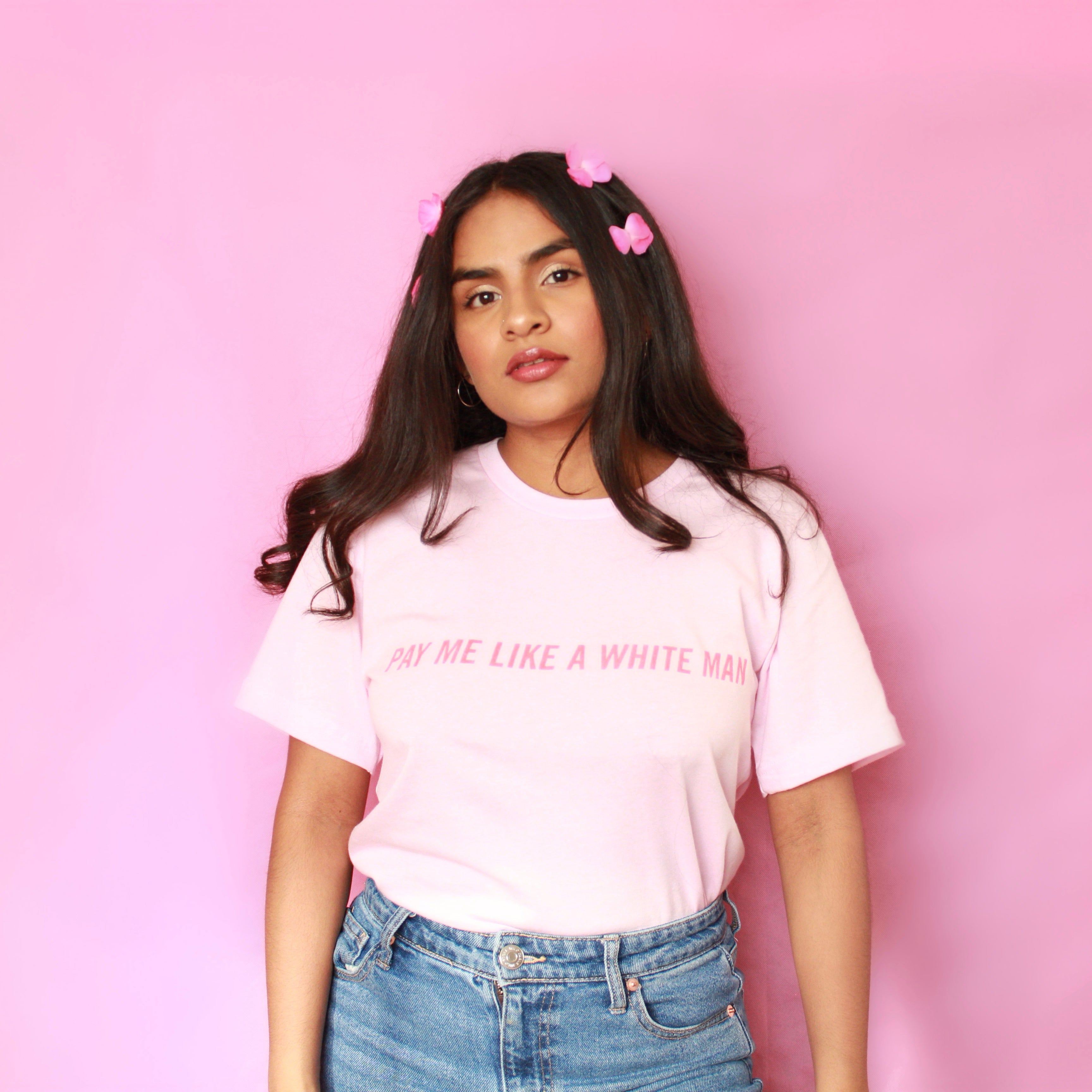 Pink oversized feminist tee that says Pay Me Like A White Man in red writing- shop feminist apparel and funny t-shirts for women