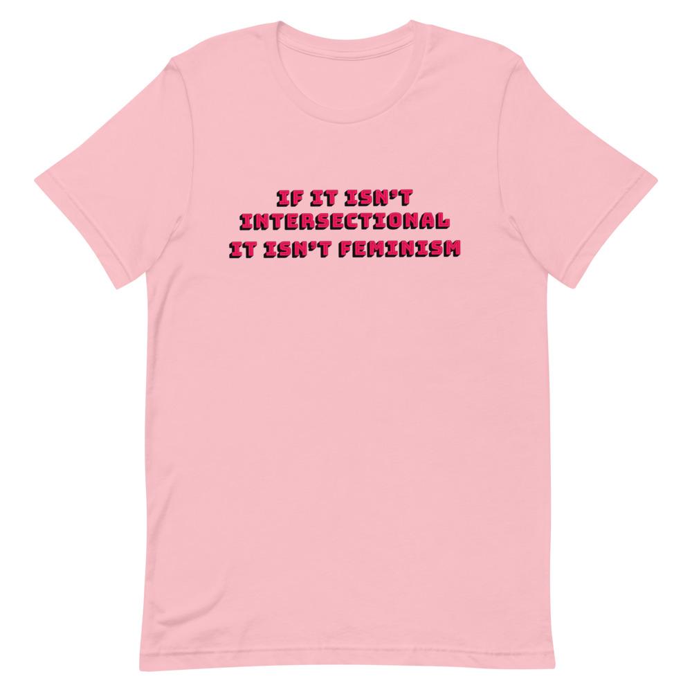 Pink feminist t-shirt with 'If It Isn’t Intersectional It Isn’t Feminism' text in red, promoting an inclusive message of empowerment and equality. Shop feminist t-shirts, pride outfits, dump him shirts, and witchy outfits.