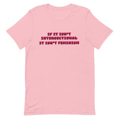 Pink feminist t-shirt with 'If It Isn’t Intersectional It Isn’t Feminism' text in red, promoting an inclusive message of empowerment and equality. Shop feminist t-shirts, pride outfits, dump him shirts, and witchy outfits.