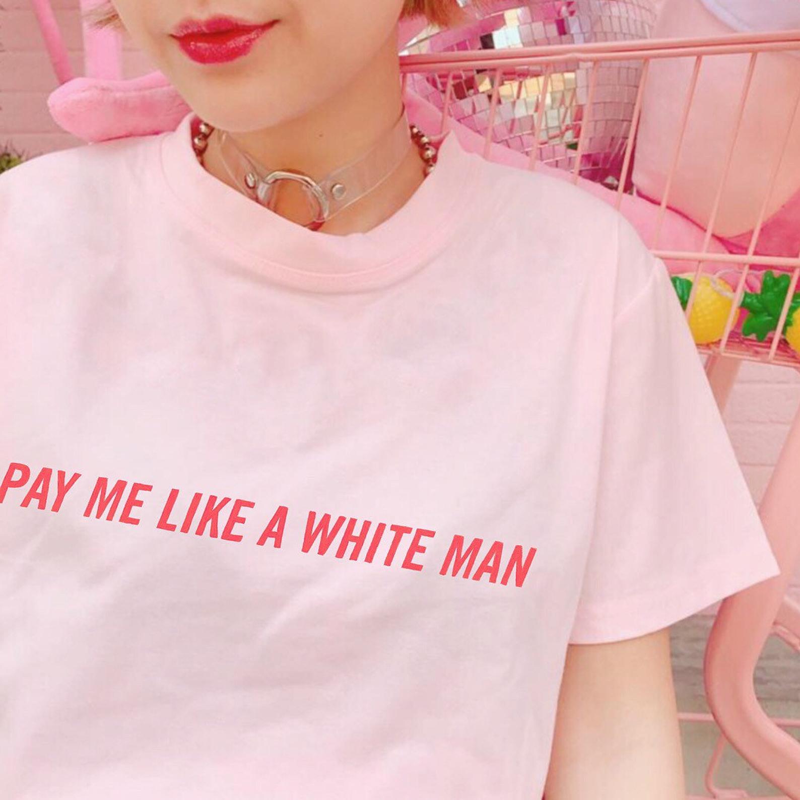 Pink Feminist shirt advocating pay equality, featuring 'Pay Me Like a White Man' slogan in red uppercase hand lettered writing. Shop Feminist Trash for feminist tshirts, dump him shirts, political clothing, pride outfits, presents for book lovers, funny t shirts for women and acab t-shirts.
