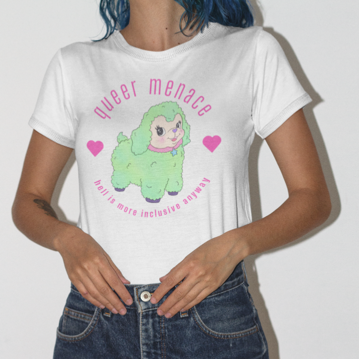 white pride themed shirt that says queer menace, hell is more inclusive anyway in bright pink writing. featuring a green smiling illustrated sheep. Shop feminist trash for pride merch and clothing for pride