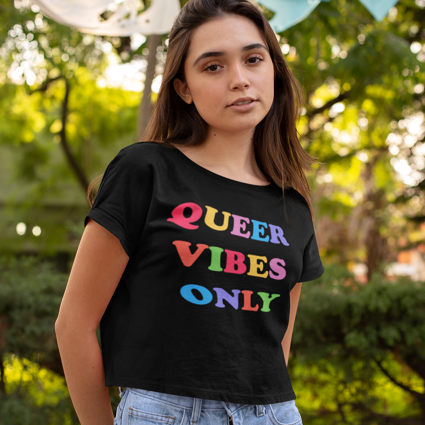 Black allover print pride crop top that says queer vibes only in rainbow writing. Grab your pride themed shirts today! Check out more pride clothes from our pride collection! Shop Feminist Trash for social justice clothing, political tees and outfits for pride.