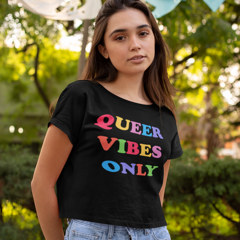 Black allover print pride crop top that says queer vibes only in rainbow writing. Grab your pride themed shirts today! Check out more pride clothes from our pride collection! Shop Feminist Trash for social justice clothing, political tees and outfits for pride.