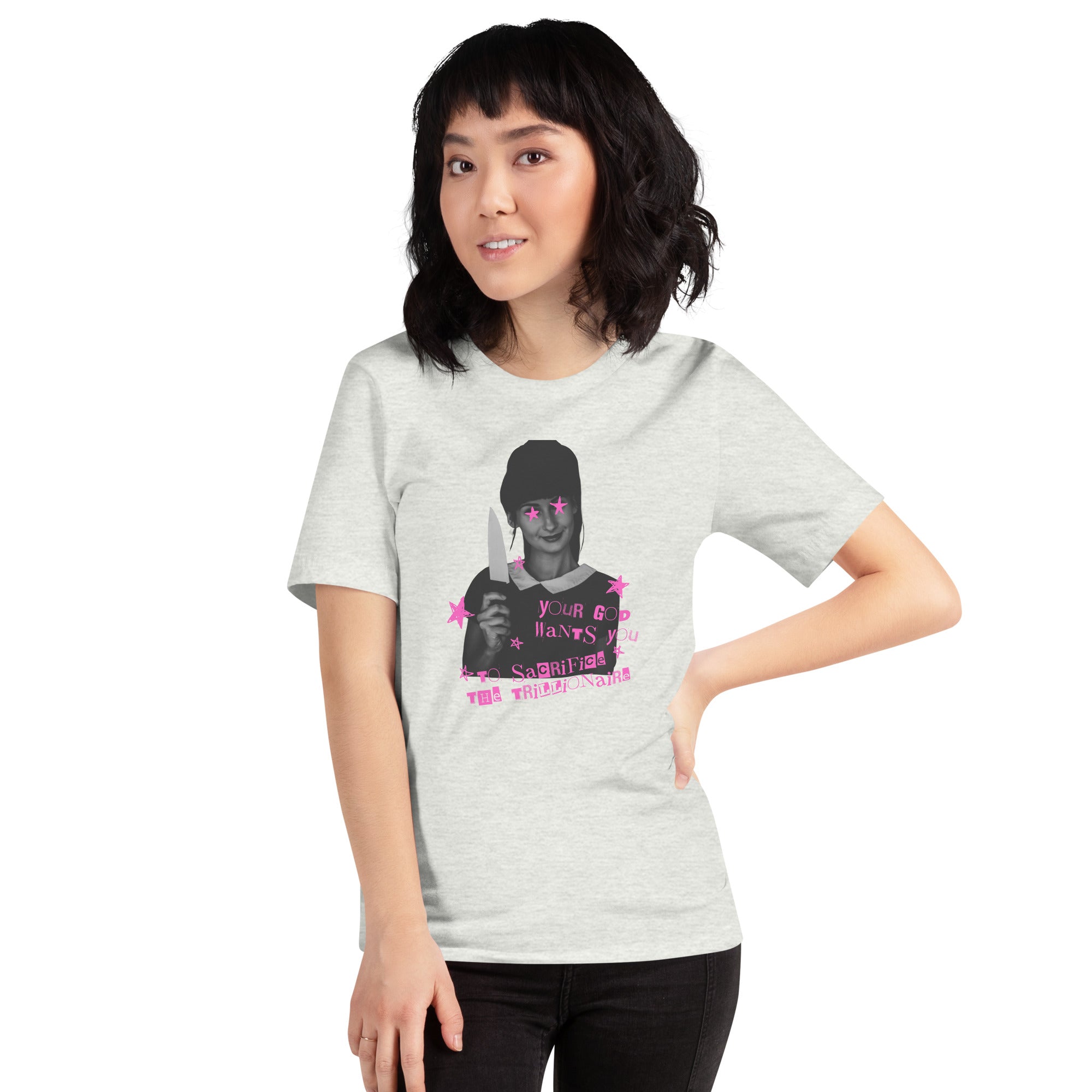 A front studio view of a woman with dark hair posing with her hand on her hip, wearing an ash grey political graphic tee printed with a bold anti-capitalist slogan targeting billionaires and Elon Musk.