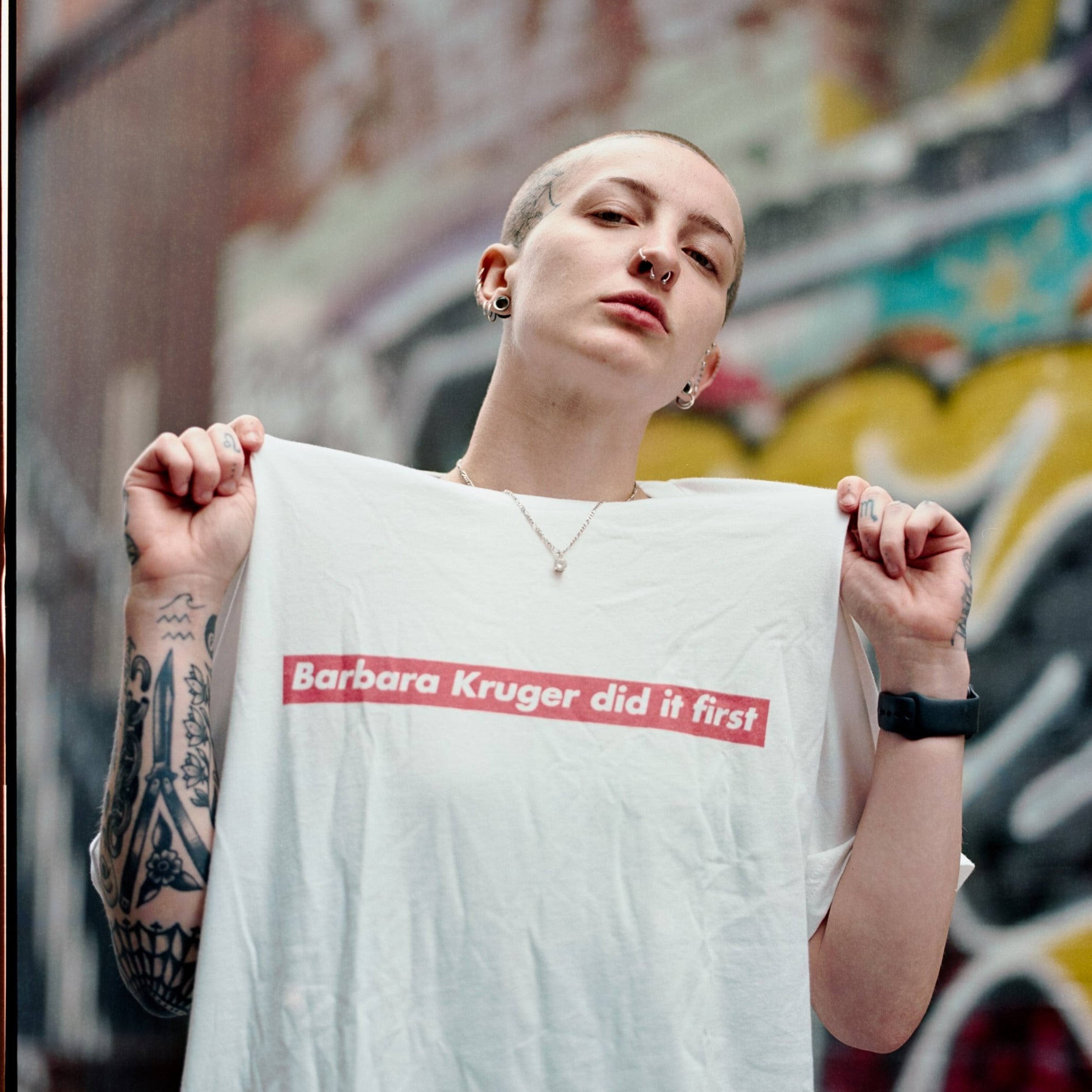 White Feminist T-Shirt that says "Barbara Kruger Did It First" in a Supreme Graphic - Shop Empowering Feminist T Shirts, acab t-shirts, political clothing, dump him shirts and pride outfits.