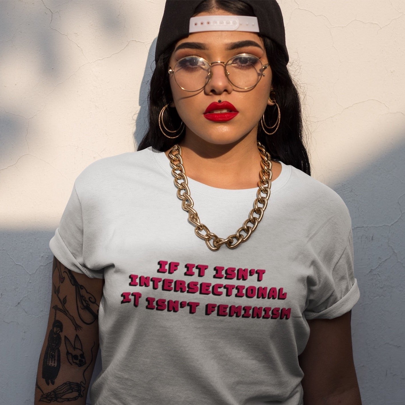 White feminist t-shirt with the empowering text 'If It Isn’t Intersectional It Isn’t Feminism' in red, advocating for inclusive feminism. Shop feminist t shirts, dump him shirts and political clothing.