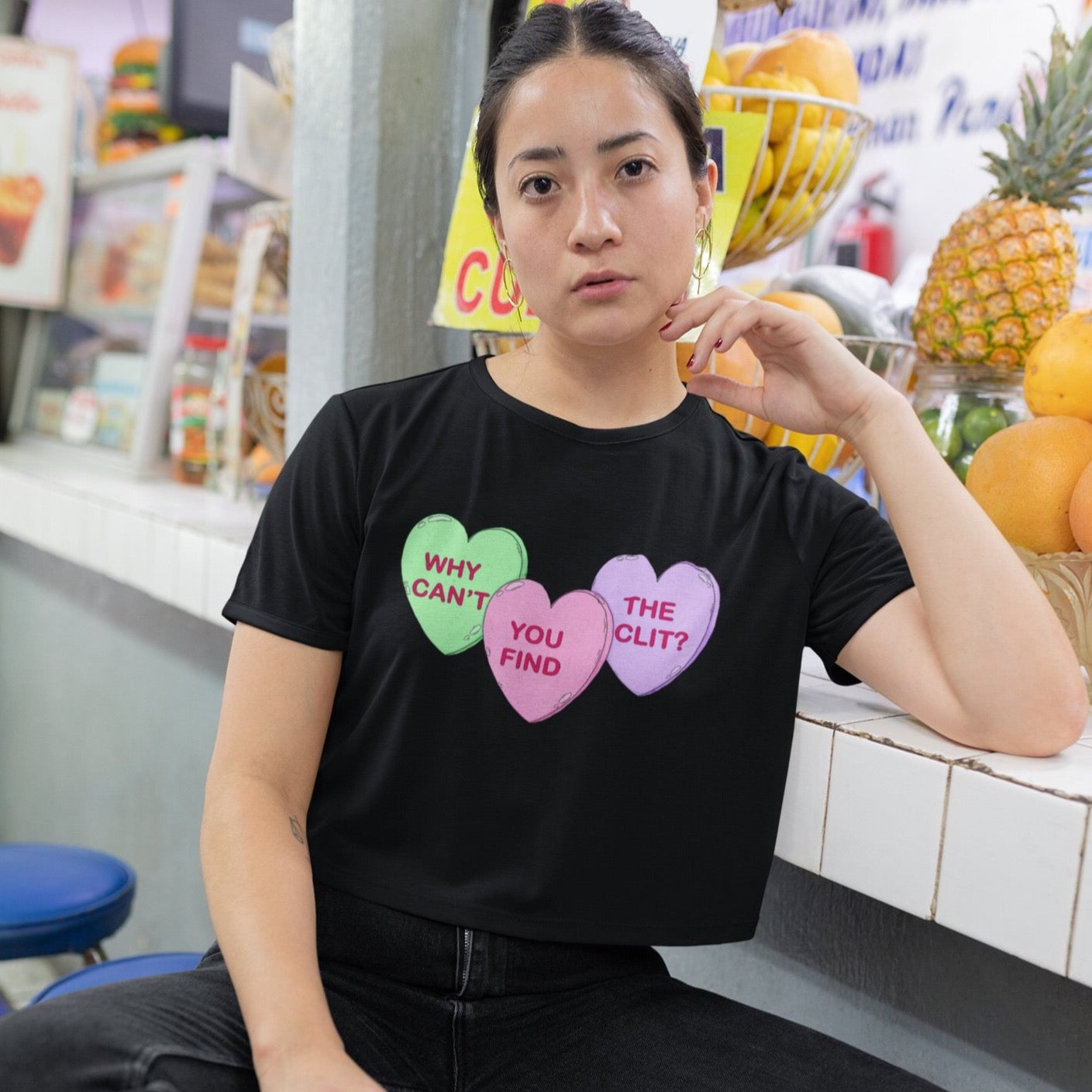 black all over print feminist crop top that says why can't you find the clit? in three candy hearts- shop feminist apparel