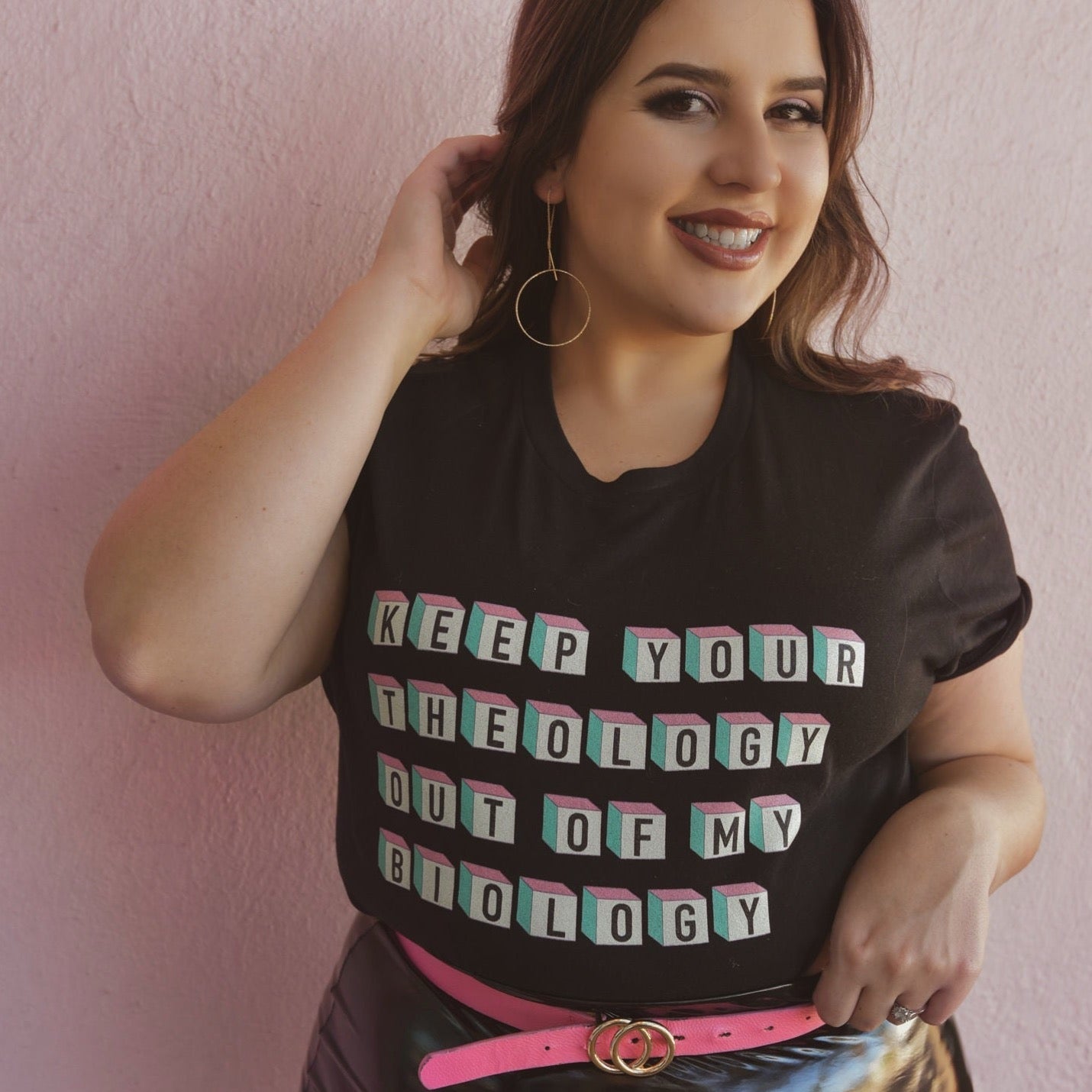 Women's rights t-shirt in black asserting "Keep Your Theology Out of My Biology- shop feminist trash store for feminist shirts, pride merch and political clothes.